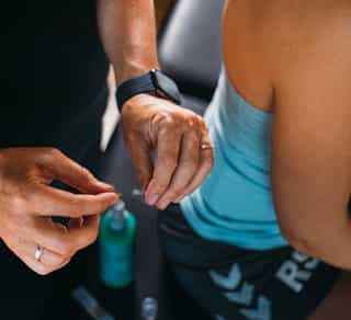 Osteopathie Therapie: Physiotherapeutin bereitet Nadeln vor für eine Behandlung. Dry Needling bei PhysioSport.