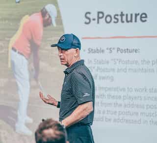 Zu sehen ist ein externer Trainer von TPI-Golfscreening für Kunden von PhysioSport Köln, der Teilnehmern eines Kurses das TPI Prinzip erläuterst.