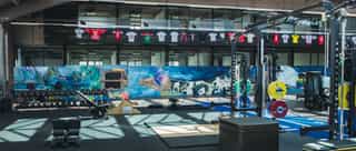 Einblick in die Trainingshalle von PhysioSport Köln mit Geräten und Trainingsstationen.