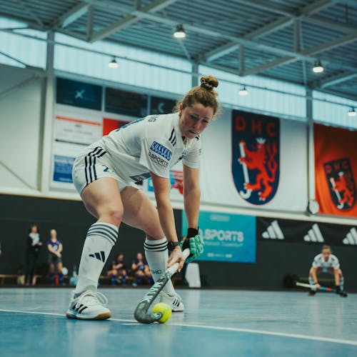 Auf dem Bild sieht man die Hockespielerin Maike Schaunig in Aktion auf dem Spielfeld, betreut von PhysioSport Köln.