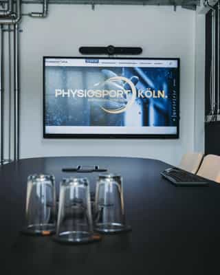 Zu sehen ist der zentrale Bildschirm im neuen Besprechungsrtaum im Headquarter von PhysioSport Köln.