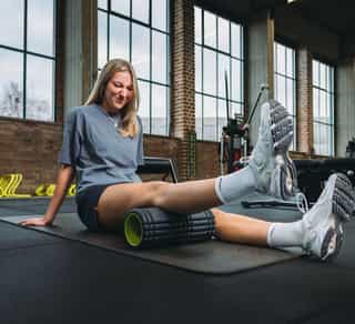 Sportlerin bei individueller Therapie gegen starke Knieschmerzen in der Trainingsanlage von PhysioSport Köln.
